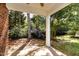Covered patio with a view of lush greenery and mature trees at 109 Longchamp Ln, Cary, NC 27519