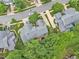 Aerial view showing a well-kept house with a gray roof, surrounded by greenery and other homes in a serene community at 11012 Southwalk Ln, Raleigh, NC 27614