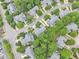 Aerial shot presenting closely-knit homes with neat landscaping and mature trees in a meticulously planned neighborhood at 11012 Southwalk Ln, Raleigh, NC 27614