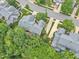Captured from above, a beautiful home sits among mature trees and landscaping, nestled in a quiet, well-planned community at 11012 Southwalk Ln, Raleigh, NC 27614