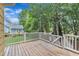A spacious wooden deck area with white railings overlooking the backyard at 11012 Southwalk Ln, Raleigh, NC 27614