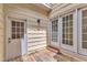 Cozy back porch featuring wooden floors, doors, and exterior lights at 11012 Southwalk Ln, Raleigh, NC 27614