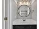 Stylish bathroom with marble countertop, round mirror, and patterned wallpaper at 11012 Southwalk Ln, Raleigh, NC 27614