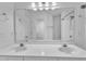 Bright bathroom featuring dual sinks, a large mirror, and a shower/tub combo at 11012 Southwalk Ln, Raleigh, NC 27614