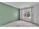 Bedroom featuring green accent wall and view to the exterior at 11012 Southwalk Ln, Raleigh, NC 27614