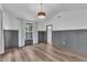 Spacious bedroom featuring wood floors, paneled wall detail, and a modern light fixture at 11012 Southwalk Ln, Raleigh, NC 27614