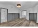 An open bedroom with modern wood floors and stylish wall accents at 11012 Southwalk Ln, Raleigh, NC 27614