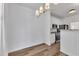Dining area with hardwood floors, white trim, and a modern chandelier at 11012 Southwalk Ln, Raleigh, NC 27614