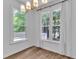 Dining Room featuring hardwood floors, white trim, and a modern chandelier at 11012 Southwalk Ln, Raleigh, NC 27614