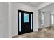 Bright entryway featuring a black front door, sidelights, hardwood flooring, and neutral paint at 11012 Southwalk Ln, Raleigh, NC 27614