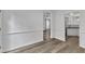 Bright hallway featuring hardwood floors and white trim leading to different rooms at 11012 Southwalk Ln, Raleigh, NC 27614