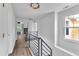 Upstairs hallway featuring modern railings and plenty of natural light at 11012 Southwalk Ln, Raleigh, NC 27614