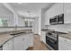 A well-lit kitchen with stainless steel appliances and granite countertops at 11012 Southwalk Ln, Raleigh, NC 27614