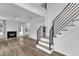 Spacious living room with fireplace, modern staircase, and hardwood floors, offering ample natural light at 11012 Southwalk Ln, Raleigh, NC 27614