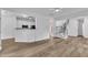 Bright, open-concept living room with hardwood floors and modern staircase at 11012 Southwalk Ln, Raleigh, NC 27614