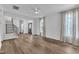 Hardwood floors, a black front door, and a modern staircase highlight this open concept living area at 11012 Southwalk Ln, Raleigh, NC 27614
