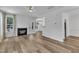 Bright and open living room featuring a fireplace, ceiling fan, and hardwood flooring at 11012 Southwalk Ln, Raleigh, NC 27614
