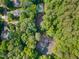 Aerial view of a neighborhood with lush trees and a tennis court, pool and houses at 1104 Berwyn Way, Raleigh, NC 27615