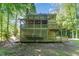 Expansive backyard featuring a multi-tiered deck with latticework and surrounded by lush greenery at 1104 Berwyn Way, Raleigh, NC 27615