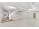 Spacious basement with tile flooring, recessed lighting, built-in white cabinets, and stairs to the upper level at 1104 Berwyn Way, Raleigh, NC 27615