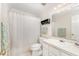 Bright bathroom with a single sink vanity, decorative towels, and tub with shower at 1104 Berwyn Way, Raleigh, NC 27615
