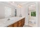 Bathroom featuring a large vanity with double sinks and a big mirror at 1104 Berwyn Way, Raleigh, NC 27615