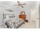 Bedroom featuring a wood dresser with mirror, ceiling fan, and access to a closet at 1104 Berwyn Way, Raleigh, NC 27615
