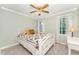 Bedroom featuring a white iron bed frame, wood fan, carpet, and an exterior view at 1104 Berwyn Way, Raleigh, NC 27615