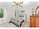 Bedroom featuring soft gray walls, carpet, a fan, and a black iron bed frame at 1104 Berwyn Way, Raleigh, NC 27615