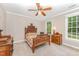 Bedroom featuring a wood bed frame, matching side table, neutral walls, and carpet at 1104 Berwyn Way, Raleigh, NC 27615