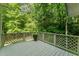 Wooden deck overlooking a lush backyard, complete with a potted plant, offering a serene outdoor space for relaxation at 1104 Berwyn Way, Raleigh, NC 27615