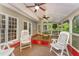 Relaxing screened-in porch with ceiling fans, comfortable seating, and views of lush greenery, perfect for enjoying the outdoors at 1104 Berwyn Way, Raleigh, NC 27615