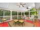 Inviting screened porch with ceiling fans, outdoor seating, and views of the surrounding greenery, ideal for relaxation at 1104 Berwyn Way, Raleigh, NC 27615
