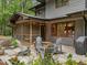 Outdoor living area with a patio, seating, and a screened-in porch for relaxing in nature at 1115 Trailwood Dr, Raleigh, NC 27606