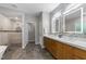 Sleek bathroom featuring a double vanity, stylish backsplash, and walk-in shower at 1115 Trailwood Dr, Raleigh, NC 27606