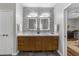 Stylish bathroom featuring a double sink vanity with backlit mirrors and modern fixtures at 1115 Trailwood Dr, Raleigh, NC 27606