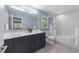 Modern bathroom with a double vanity, sleek fixtures, and a bright, refreshing atmosphere at 1115 Trailwood Dr, Raleigh, NC 27606