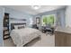 Serene bedroom with large windows, a stylish bed, and a peaceful, light-filled atmosphere at 1115 Trailwood Dr, Raleigh, NC 27606