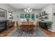 Elegant dining room featuring a modern light fixture and a large window overlooking a private outdoor space at 1115 Trailwood Dr, Raleigh, NC 27606