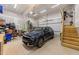 Spacious two-car garage with ample storage space and a modern blue SUV at 1115 Trailwood Dr, Raleigh, NC 27606
