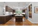 Gourmet kitchen showcasing stainless steel appliances, custom cabinetry, a wine rack, and a granite-topped island at 1115 Trailwood Dr, Raleigh, NC 27606