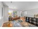 Bright living room featuring hardwood floors, neutral walls and a comfortable seating area at 1115 Trailwood Dr, Raleigh, NC 27606