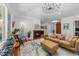 Cozy living room showcasing a fireplace, stylish decor, a comfortable couch, and a decorative area rug at 1115 Trailwood Dr, Raleigh, NC 27606