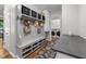 Functional mudroom with built-in storage, a bench, and laundry machines for added convenience at 1115 Trailwood Dr, Raleigh, NC 27606