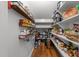 Well-organized pantry featuring wood shelves, white shelves, and a hardwood floor at 1115 Trailwood Dr, Raleigh, NC 27606