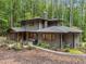 Beautiful two-story home with a screened porch and stone patio in wooded setting at 1115 Trailwood Dr, Raleigh, NC 27606
