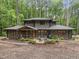 Beautiful two-story home with a screened porch and stone patio in wooded setting at 1115 Trailwood Dr, Raleigh, NC 27606