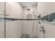 Modern shower with tiled walls, a rainfall shower head, and built-in niche at 1115 Trailwood Dr, Raleigh, NC 27606