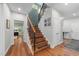 Modern staircase with wooden steps, metal railings and natural light creating a welcoming entry at 1115 Trailwood Dr, Raleigh, NC 27606