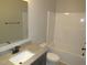 Bathroom featuring vanity with granite countertops and modern fixtures at 119 Oak Ridge Rd, Franklinton, NC 27525